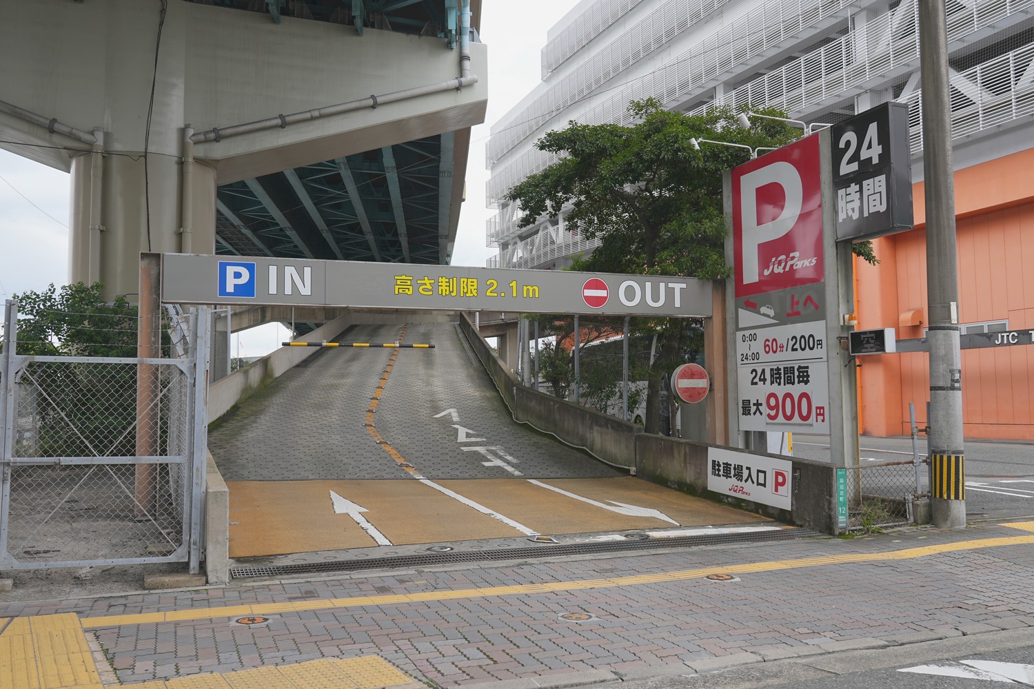 駐車場の入口です。高さ制限2.1m、24時間営業で、料金看板もここにあります。